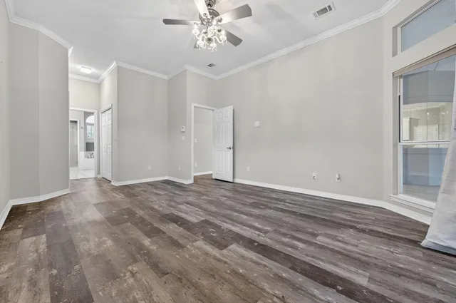a view of an empty room with wooden floor