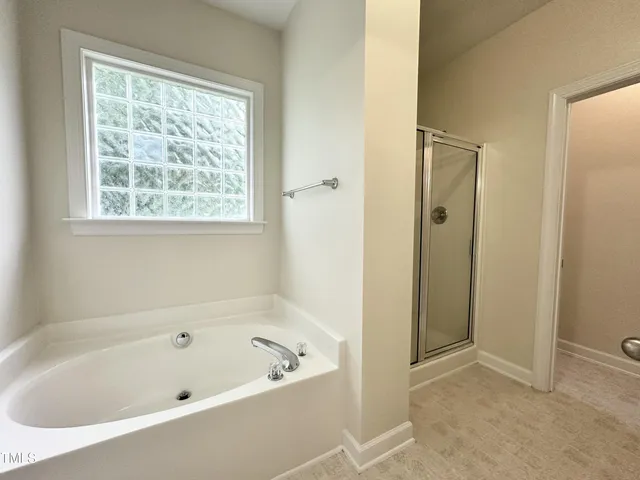 a bathroom with a bathtub and shower