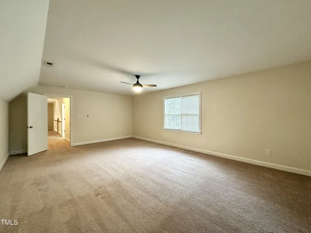 an empty room with a empty space and windows