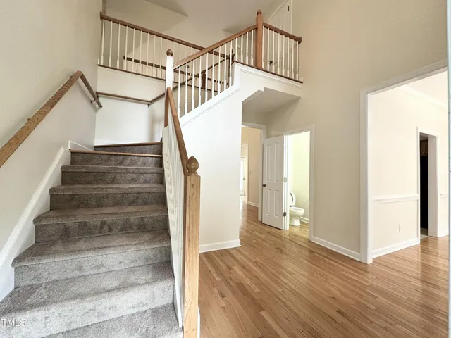a view of entryway and hall with wooden floor