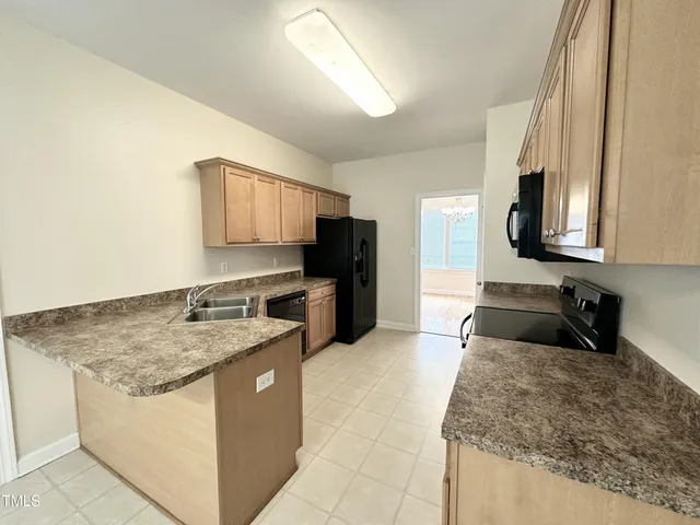a kitchen with a stove a sink and a refrigerator