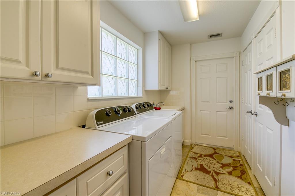 7390 Emilia Lane Naples, FL 34114 - Photo 12 of 25 a utility room with dryer and washer