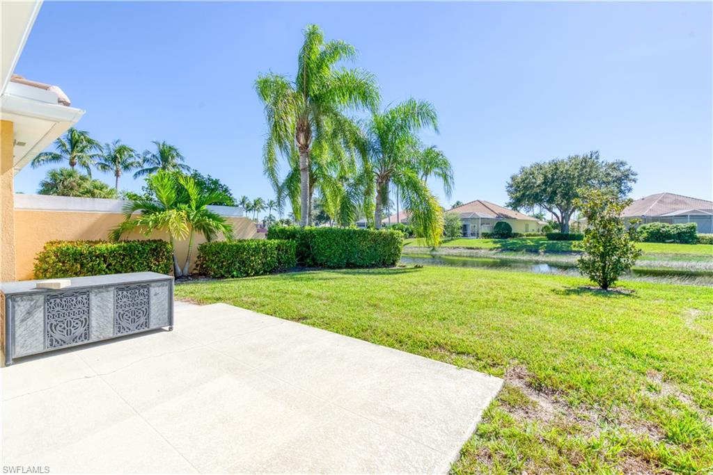 7390 Emilia Lane Naples, FL 34114 - Photo 15 of 25 a view of a garden with a bench