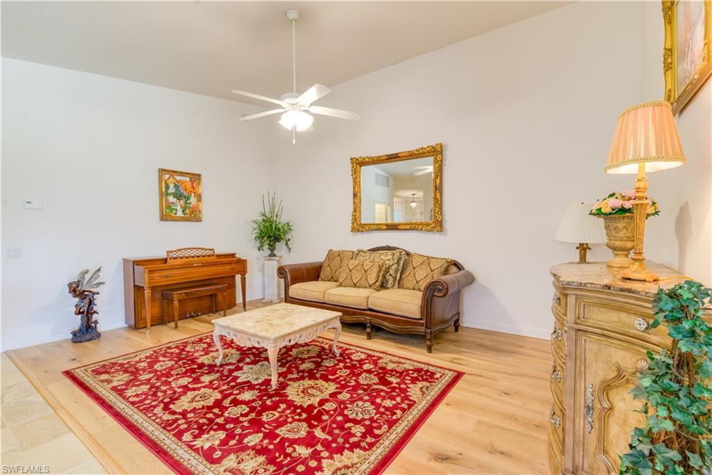 7390 Emilia Lane Naples, FL 34114 - Photo 4 of 25 a living room with a couch and a table