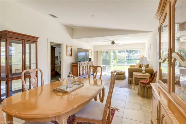 a view of a dining room with furniture large windows and wooden floor