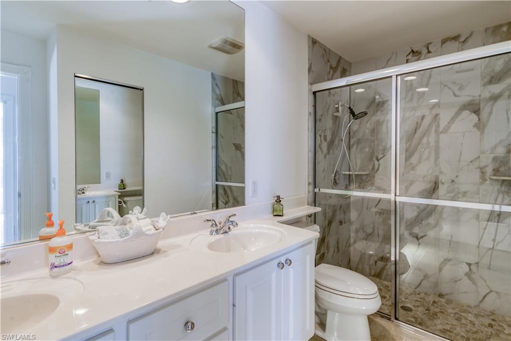7390 Emilia Lane Naples, FL 34114 - Photo 8 of 25 a bathroom with a sink toilet and shower