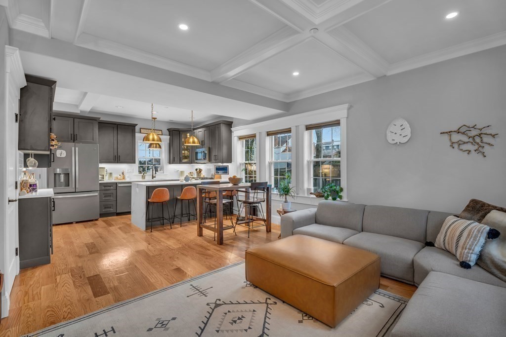 a living room filled with furniture and a large window
