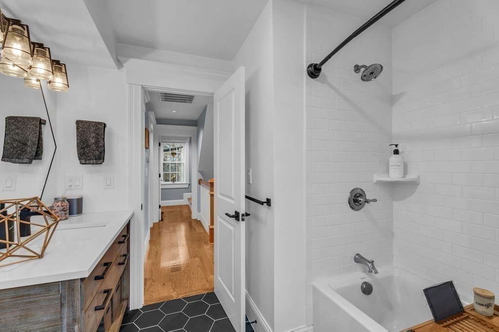 106 Bridge Street, Unit 8 Salem, MA 01970 - Photo 11 of 30 a bathroom with a tub sink and mirror