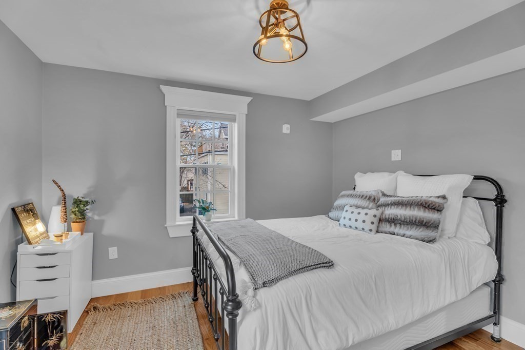 106 Bridge Street, Unit 8 Salem, MA 01970 - Photo 15 of 30 a bedroom with a bed and wooden floor