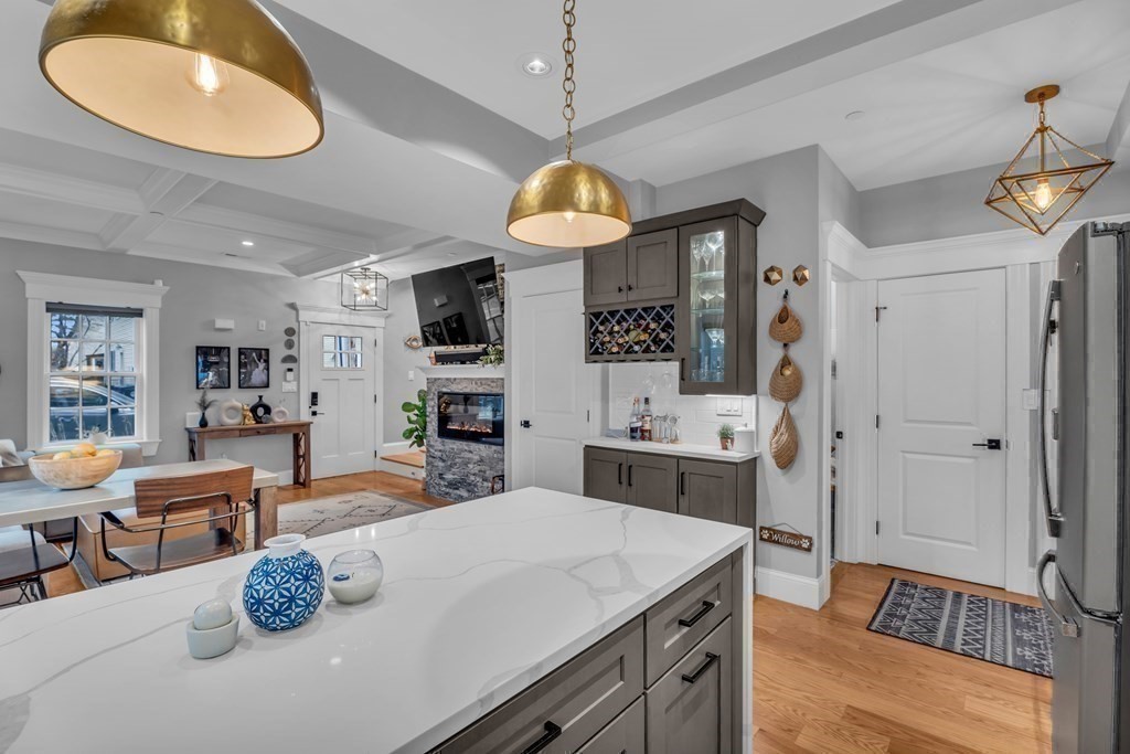 106 Bridge Street, Unit 8 Salem, MA 01970 - Photo 5 of 30 a kitchen with stainless steel appliances wooden floor dining table and chairs