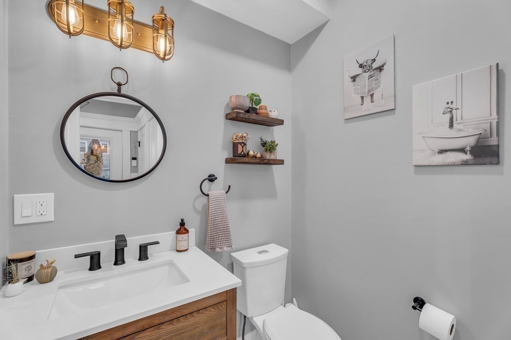 106 Bridge Street, Unit 8 Salem, MA 01970 - Photo 8 of 30 a bathroom with a toilet mirror and vanity