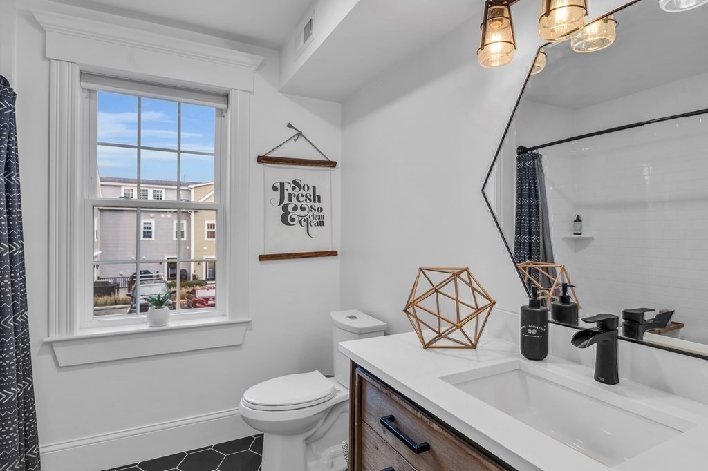 106 Bridge Street, Unit 8 Salem, MA 01970 - Photo 10 of 30 a bathroom with a sink a toilet and shower curtain