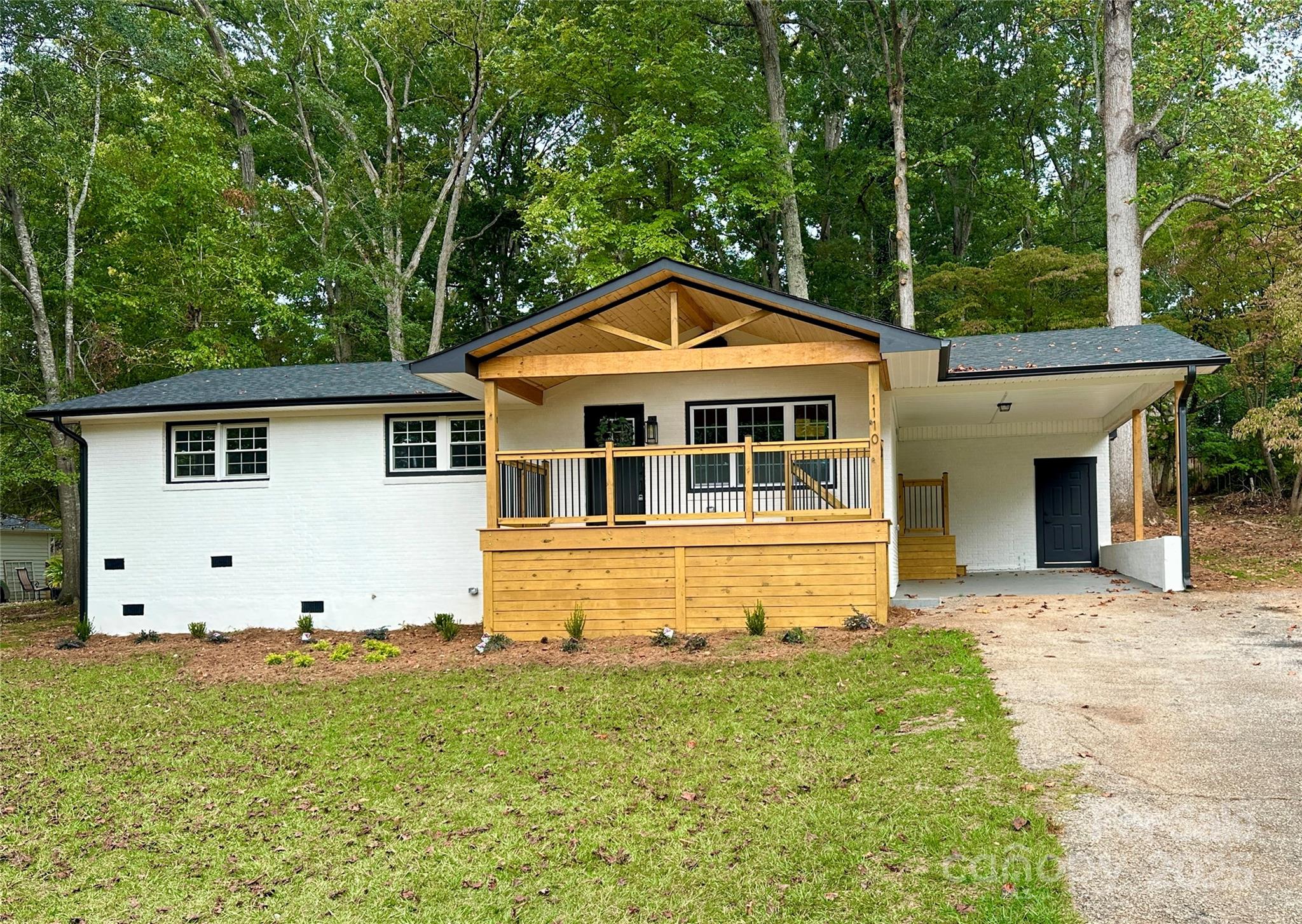 1110 West Edgemont Drive Lancaster, SC 29720 - Photo 3 of 27 a front view of a house with a garden