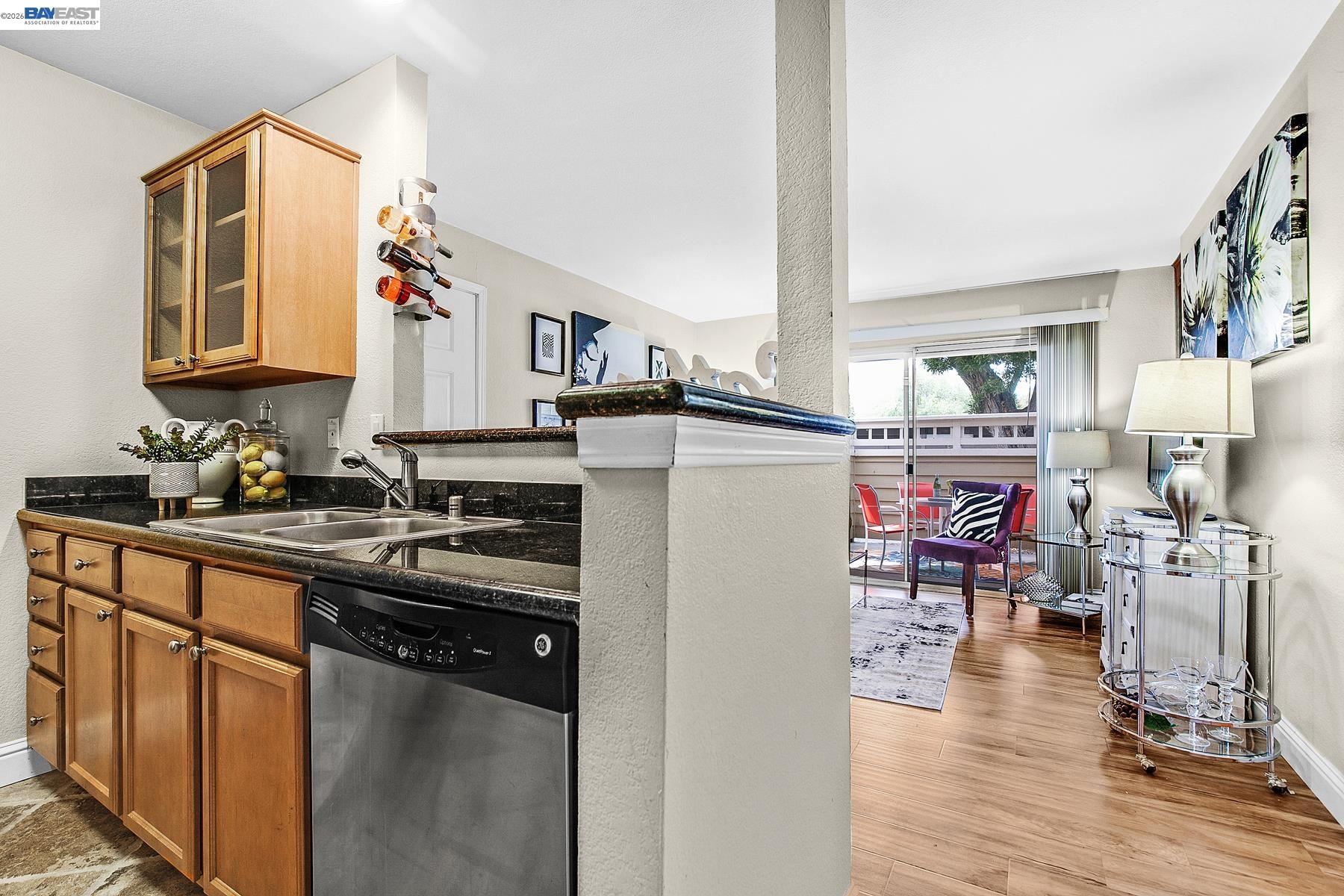 150 Reflections Drive, Unit 13 San Ramon, CA 94583 - Photo 11 of 33 a kitchen with stainless steel appliances granite countertop a refrigerator a stove top oven a sink dishwasher and dining table with wooden floor