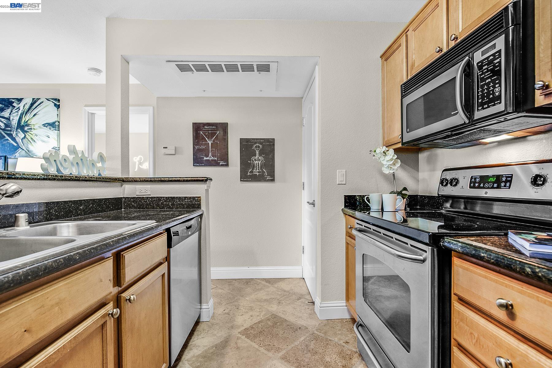 150 Reflections Drive, Unit 13 San Ramon, CA 94583 - Photo 13 of 33 a kitchen with stainless steel appliances granite countertop a stove and a microwave