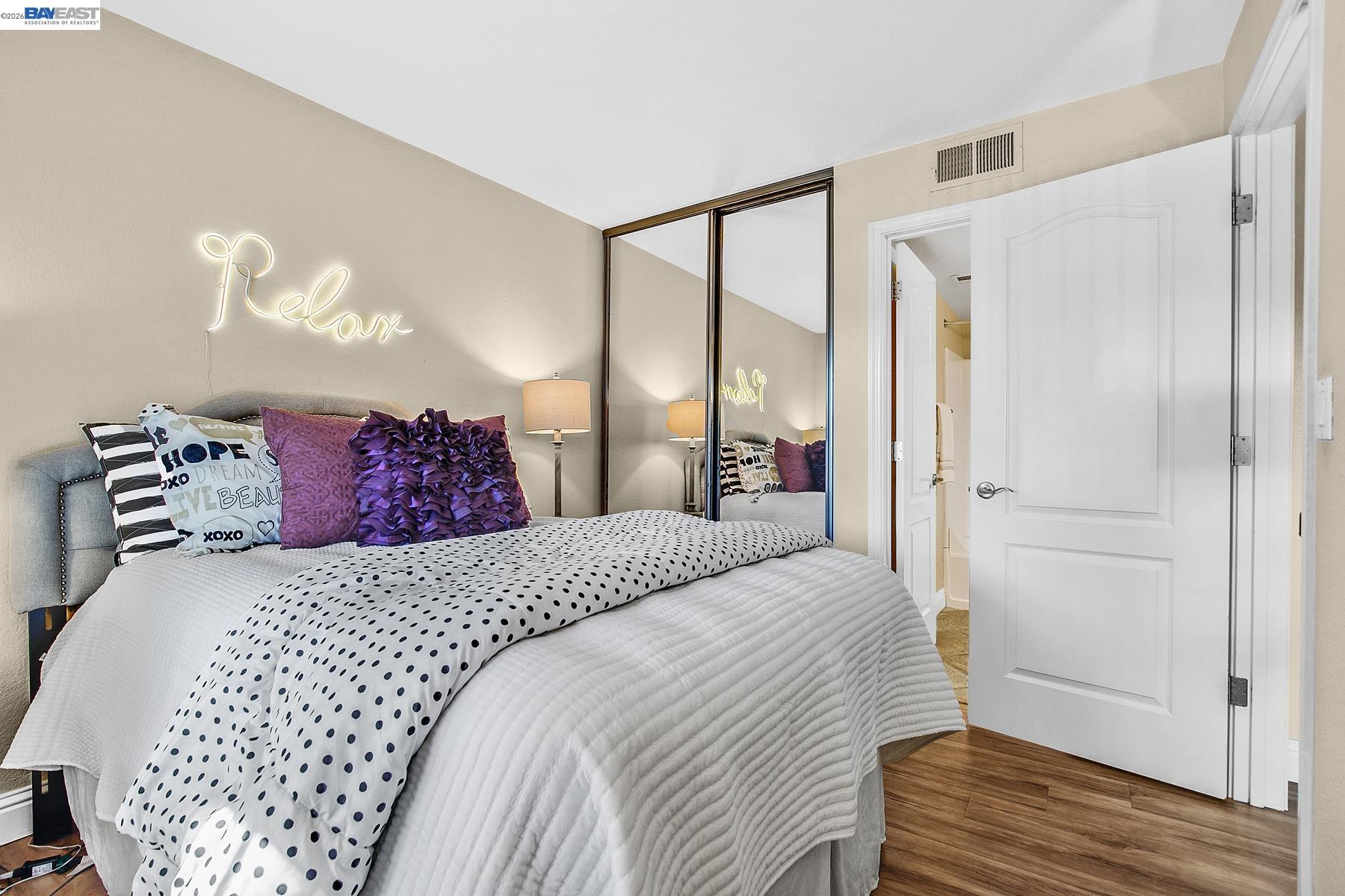 150 Reflections Drive, Unit 13 San Ramon, CA 94583 - Photo 20 of 33 a bedroom with a large bed and a chandelier