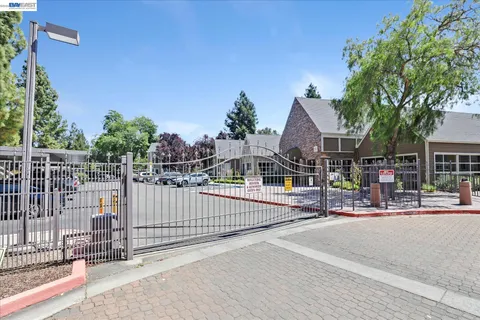 a view of a brick house with a bench in front of it