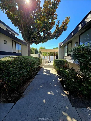 a front view of a house with a yard and outdoor seating