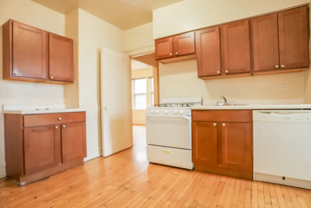 a view of a kitchen with wooden floor