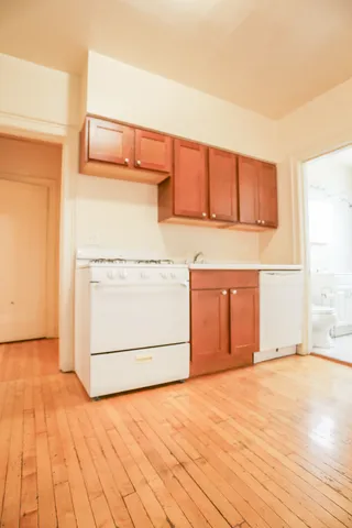 a view of a room with wooden floor and cabinet
