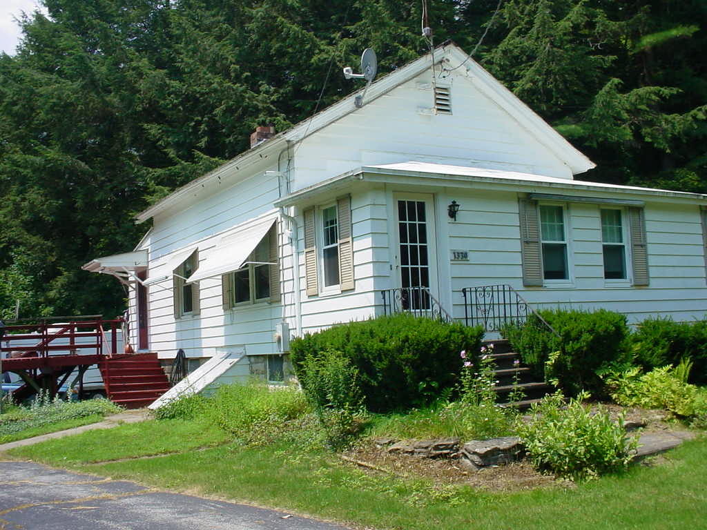 1330 Wade Inn Road Becket, MA 01223 - Photo 1 of 17 a front view of a house with a yard