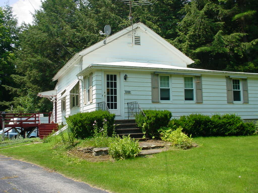 1330 Wade Inn Road Becket, MA 01223 - Photo 13 of 17 a front view of a house with a yard