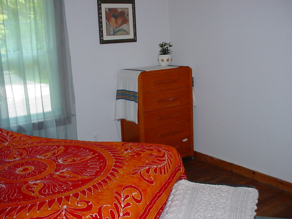 1330 Wade Inn Road Becket, MA 01223 - Photo 8 of 17 a bedroom with a bed and wooden floor
