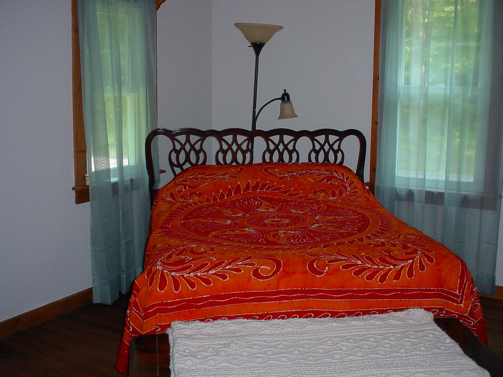1330 Wade Inn Road Becket, MA 01223 - Photo 10 of 17 a large bed sitting in a bedroom next to a window