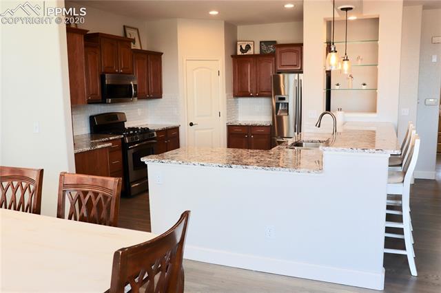 2473 Cinnabar Road Colorado Springs, CO 80921 - Photo 8 of 22 view from sliding door to deck into dining room and kitchen