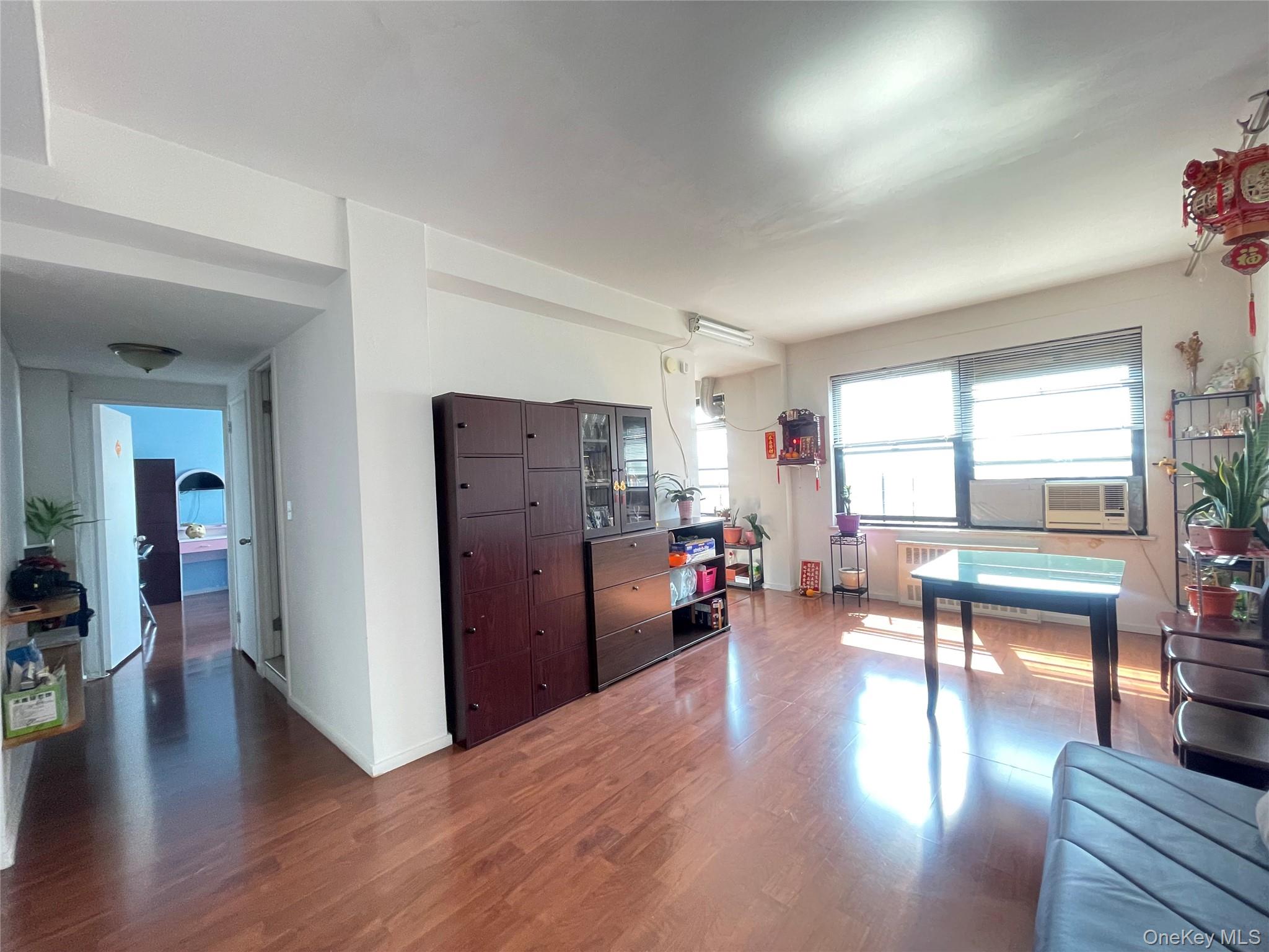 99-72 66th Road, Unit 9S Queens, NY 11374 - Photo 1 of 9 a view of a livingroom with furniture hardwood floor and a living room