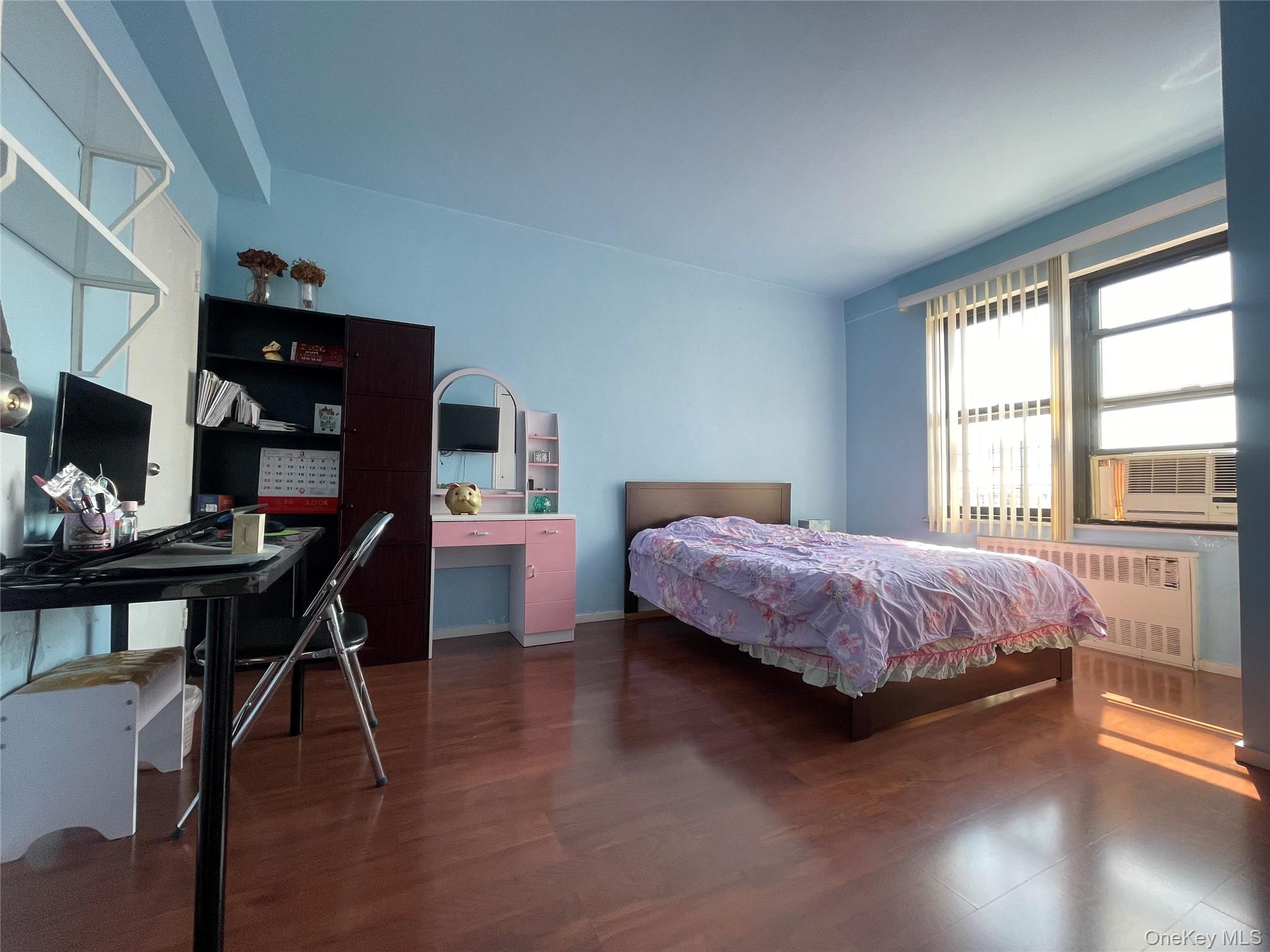 99-72 66th Road, Unit 9S Queens, NY 11374 - Photo 2 of 9 a bedroom with a bed and a tv on table
