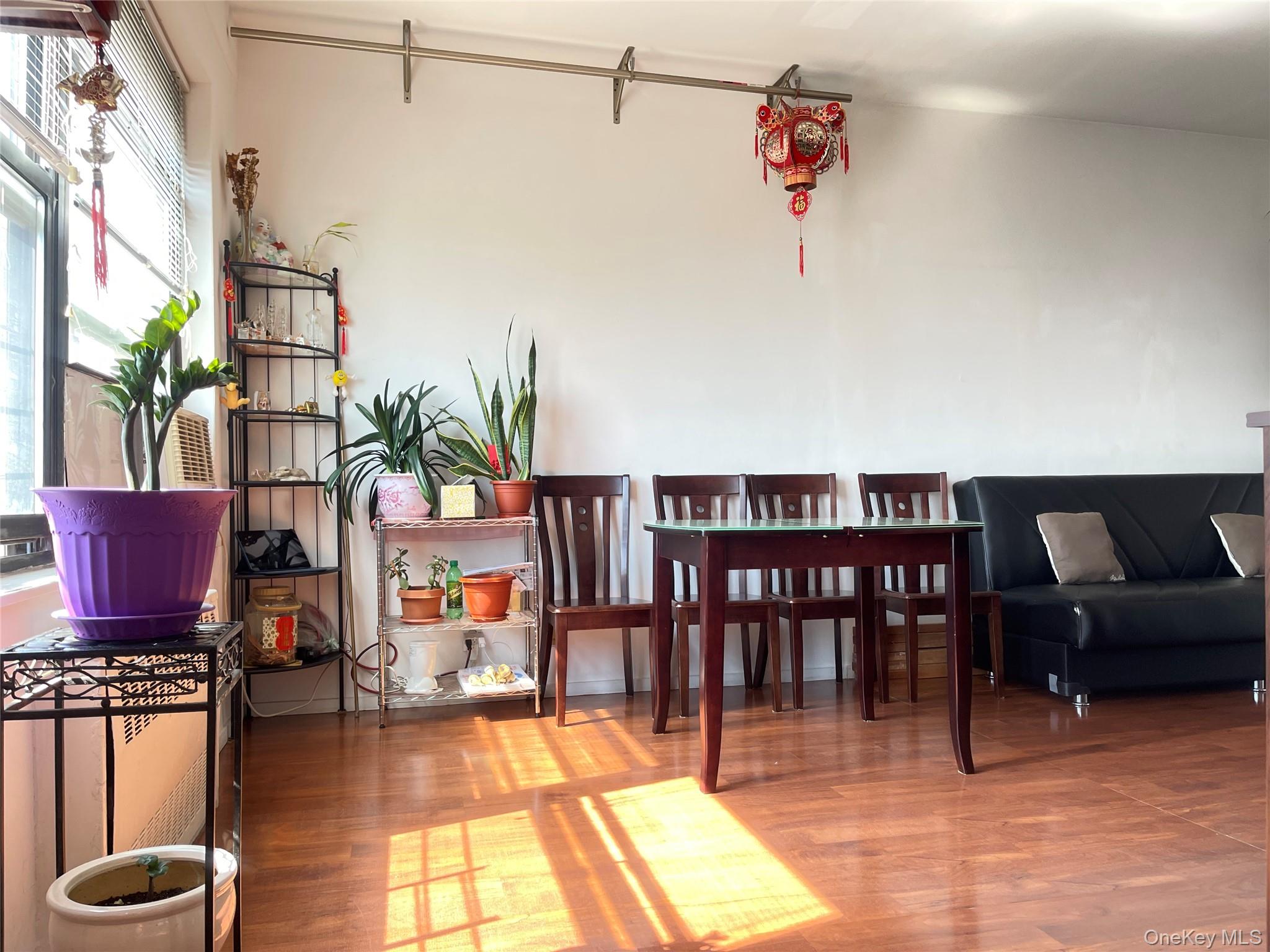 99-72 66th Road, Unit 9S Queens, NY 11374 - Photo 4 of 9 a living room with furniture a rug and a floor to ceiling window