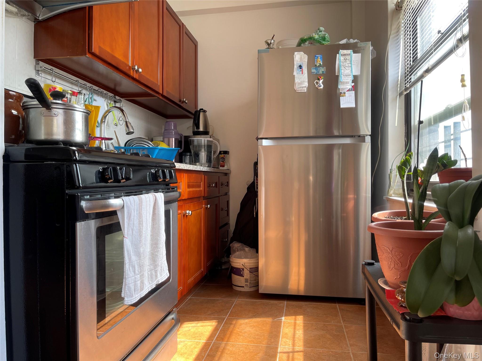 99-72 66th Road, Unit 9S Queens, NY 11374 - Photo 7 of 9 a kitchen with stainless steel appliances granite countertop a refrigerator and a stove