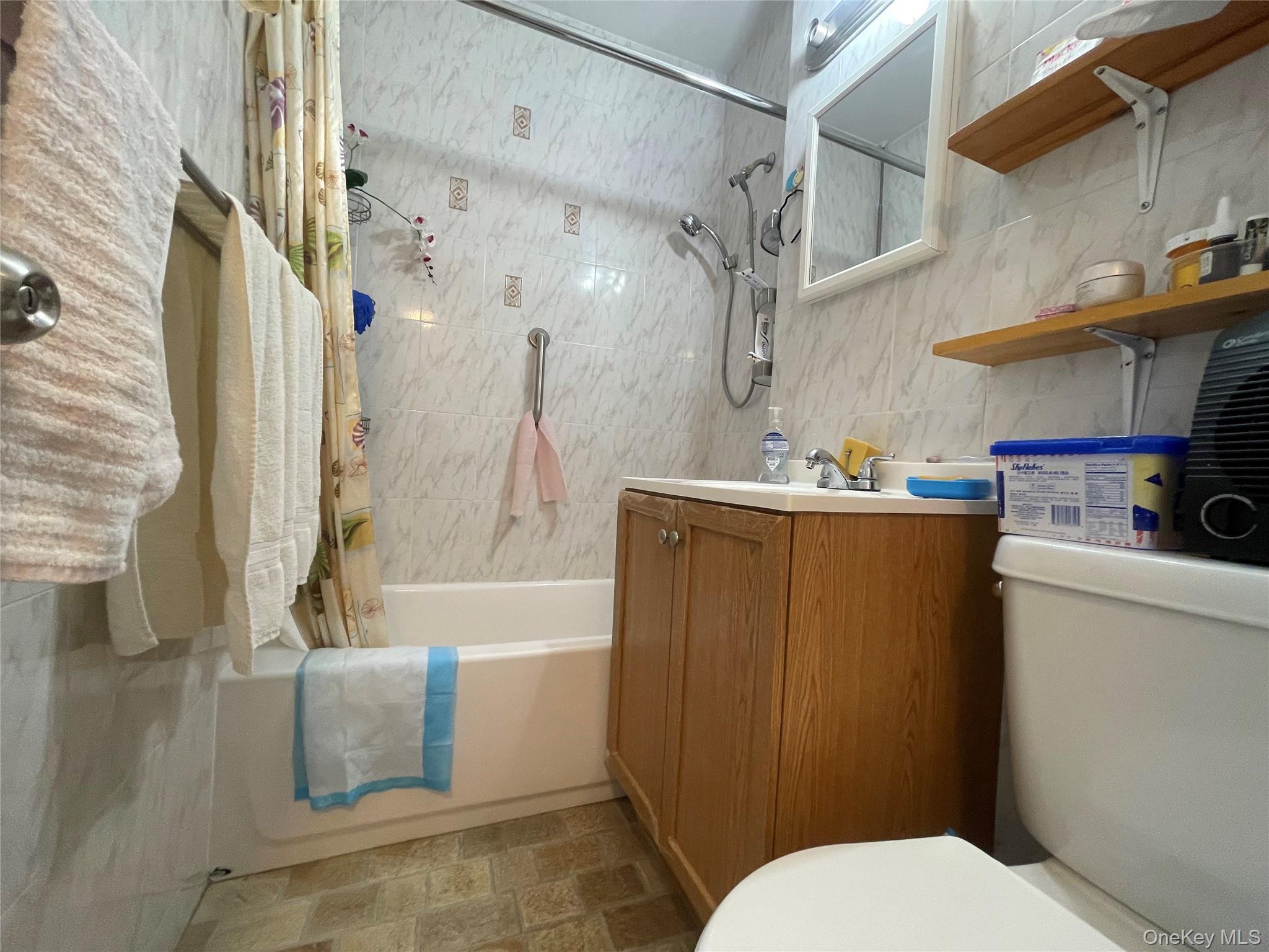 99-72 66th Road, Unit 9S Queens, NY 11374 - Photo 8 of 9 a bathroom with a sink toilet and shower