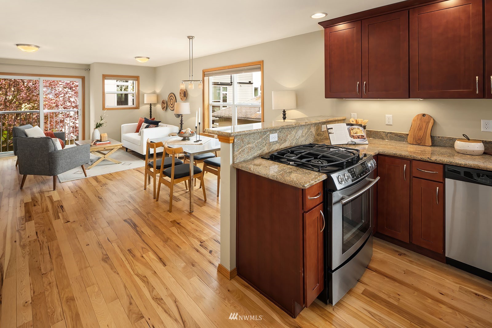 514 North 46th Street, Unit B Seattle, WA 98103 - Photo 14 of 30 a kitchen with a stove a sink a dining table and chairs