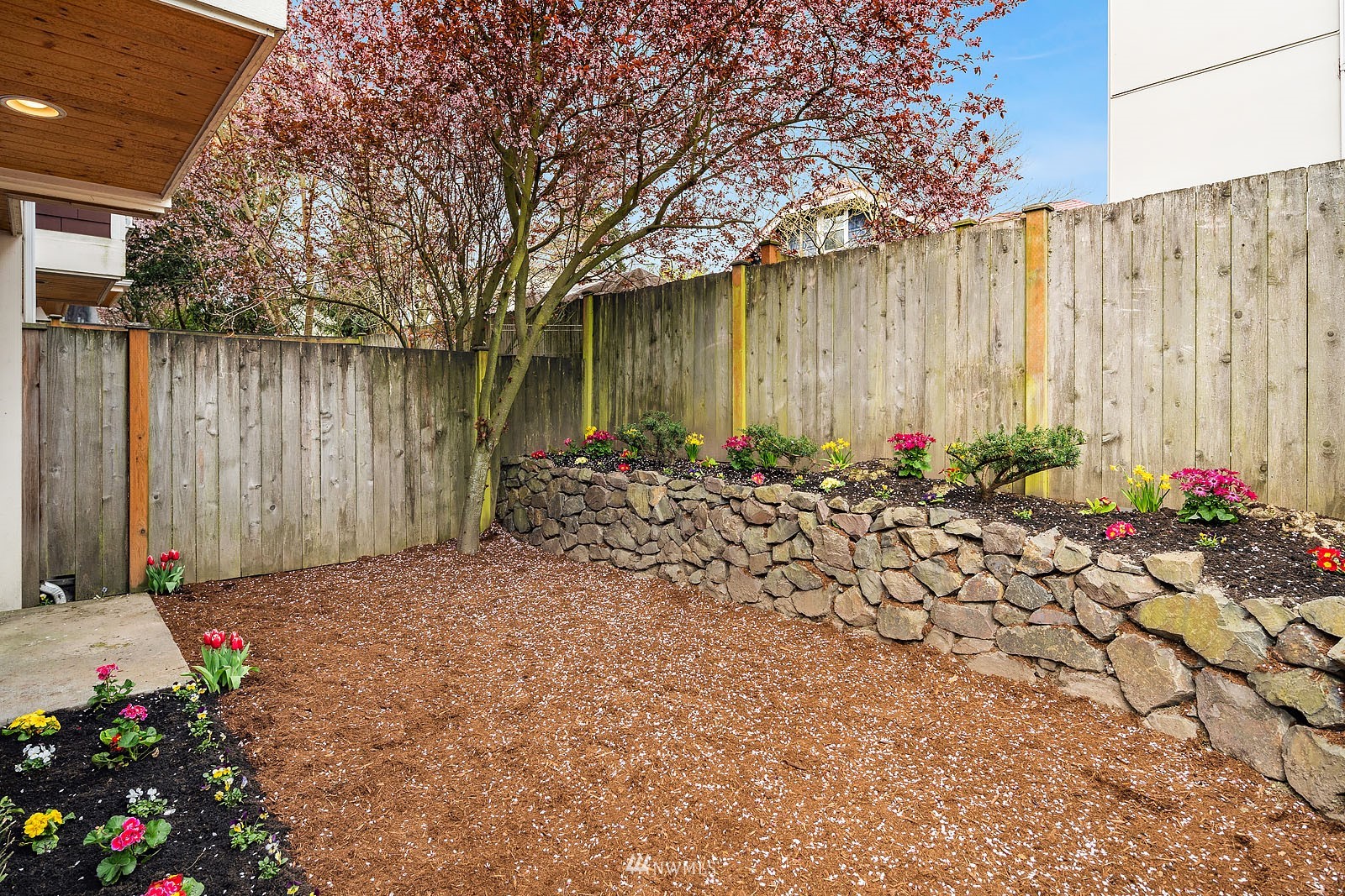 514 North 46th Street, Unit B Seattle, WA 98103 - Photo 24 of 30 a view of a backyard with a flower garden