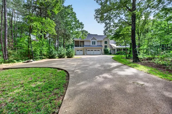 a pathway of a house with a yard