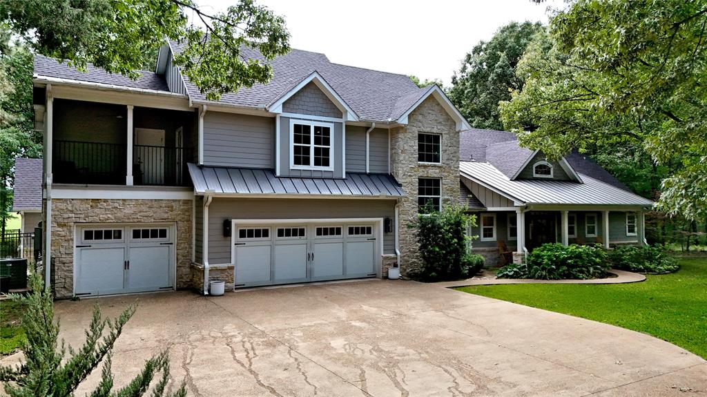 4747 Stonebridge Athens, TX 75751 - Photo 2 of 40 a front view of a house with a garden and plants
