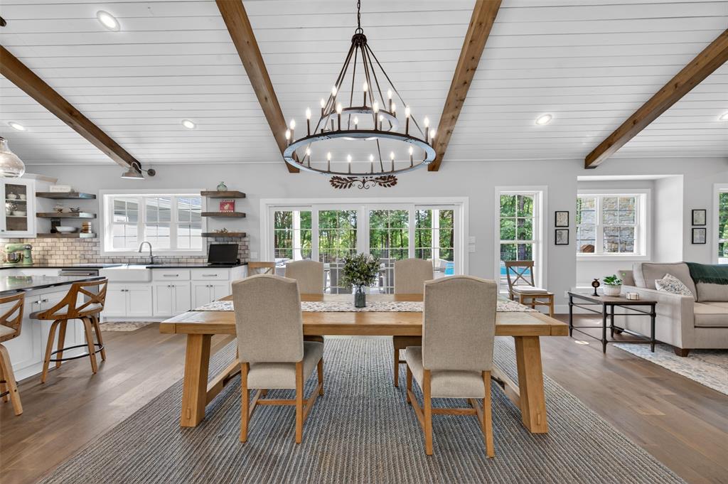 4747 Stonebridge Athens, TX 75751 - Photo 10 of 40 a dining room with wooden floor a chandelier a glass table and chairs