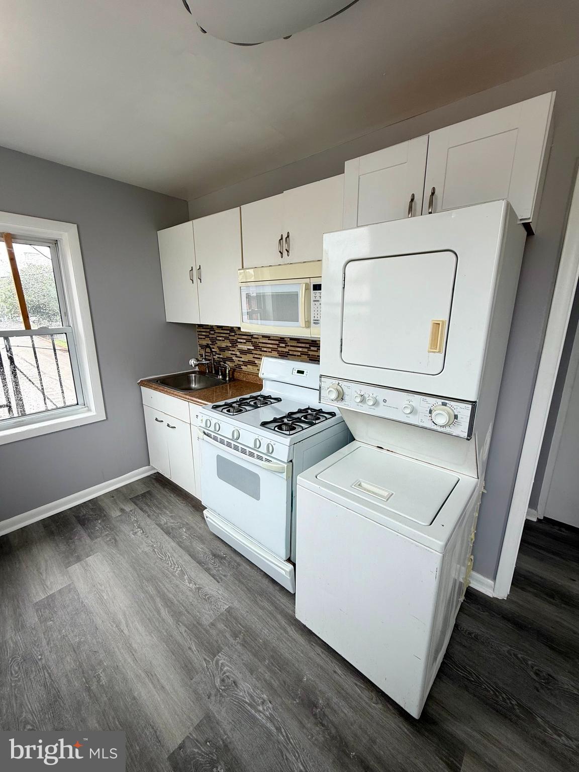1001 Light Street, Unit 3 Baltimore, MD 21230 - Photo 11 of 14 a kitchen with a stove a sink and a microwave