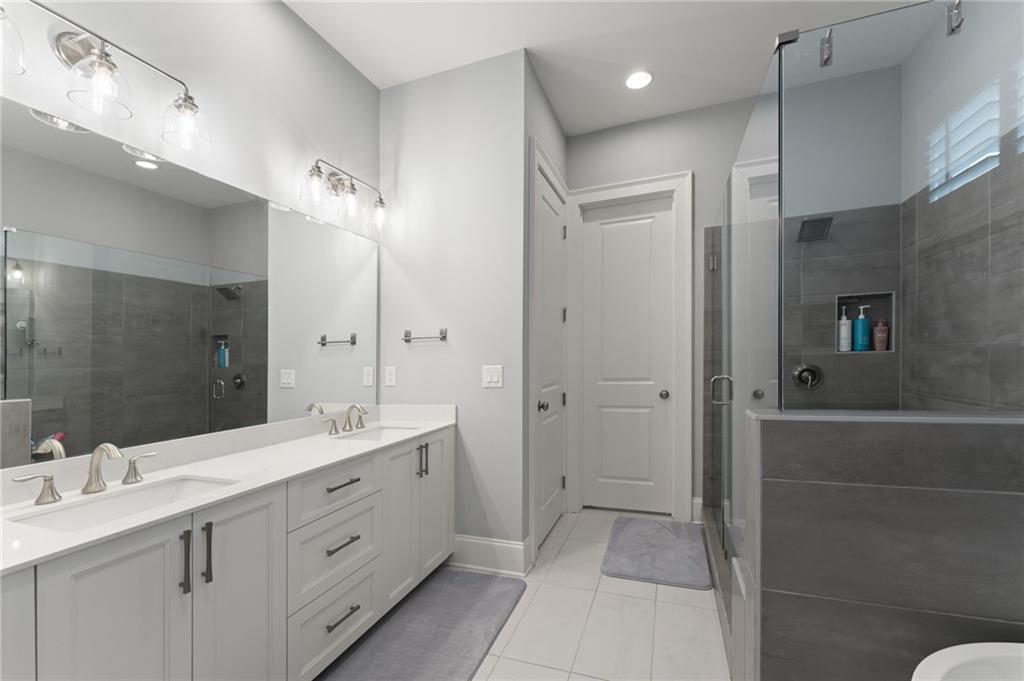 7170 Lullwater Road Cumming, GA 30040 - Photo 36 of 86 a spacious bathroom with a double vanity sink mirror and double