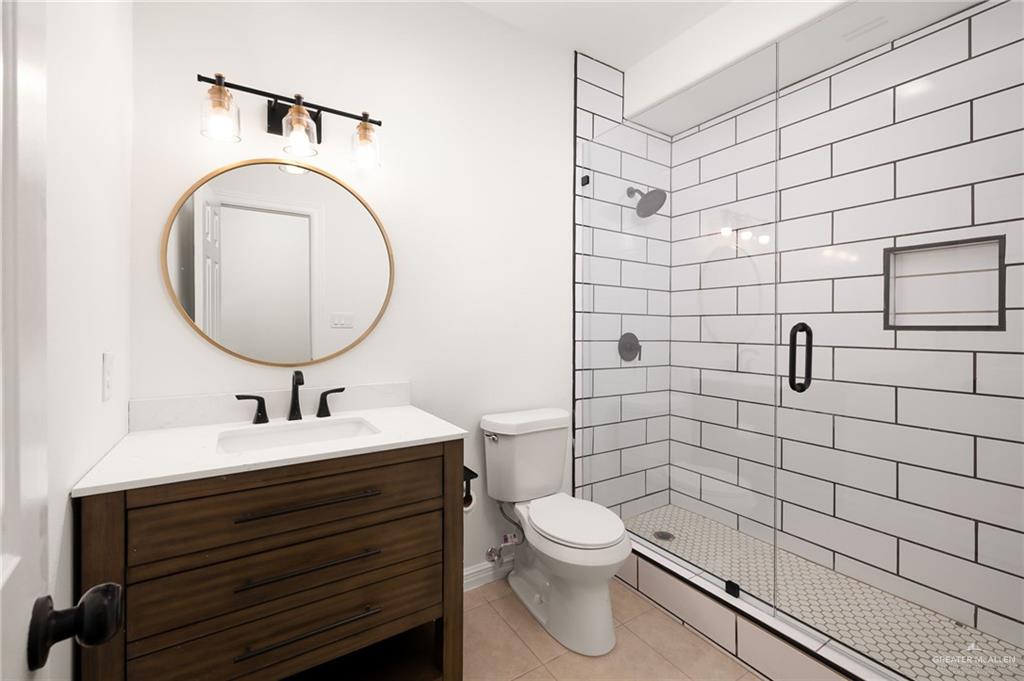 424 Canary Avenue McAllen, TX 78504 - Photo 12 of 17 a bathroom with a sink toilet and shower