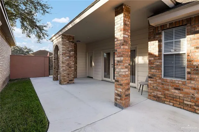 a view of an outdoor space with porch and wooden fence