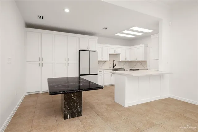a kitchen with stainless steel appliances a sink stove and refrigerator