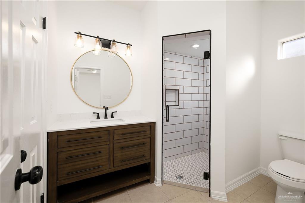 424 Canary Avenue McAllen, TX 78504 - Photo 10 of 17 a bathroom with a sink a toilet and shower