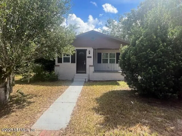a front view of a house with a yard and a garage