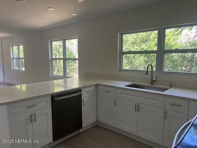 a kitchen with a sink and large window