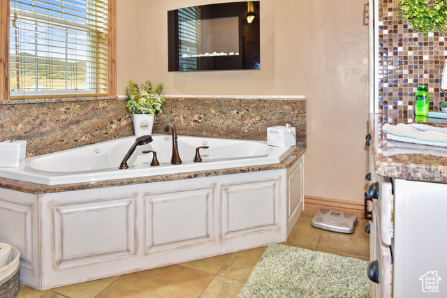 1500 Fish Creek Road Bancroft, ID 83217 - Photo 10 of 45 Full bath with a whirlpool tub and light tile patterned flooring