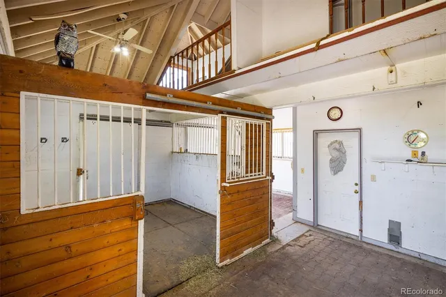 a bedroom with furniture and a large window