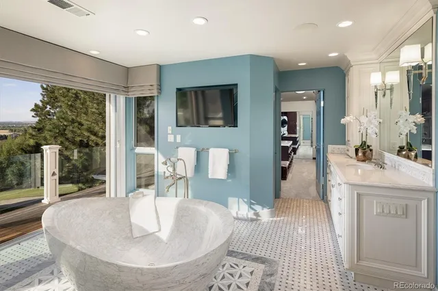 a large living room with a couch and a flat screen tv